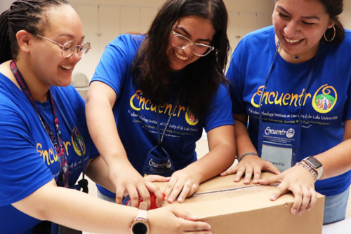 students working to close box for mission retreat